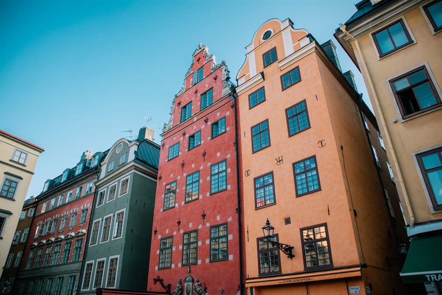 Tall orange, red and green gabled houses on Stortorget square in Gamla Stan, Stockholm