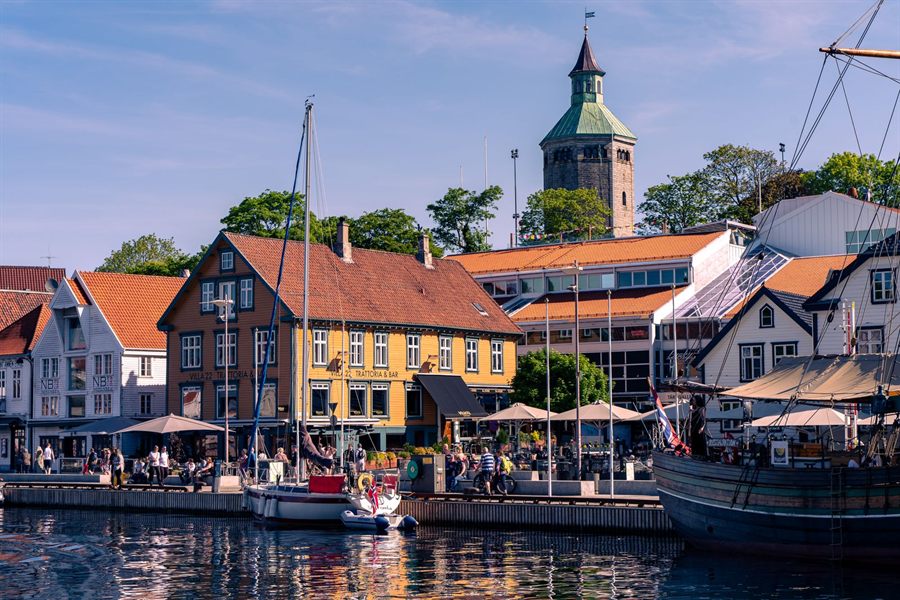 Waterfront cafes and colorful buildings on Stavanger harbor on a summer day