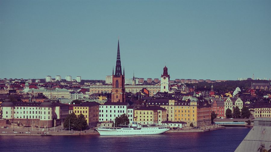 Stockholm Old Town skyline with Riddarholmen church and a white boat on the water