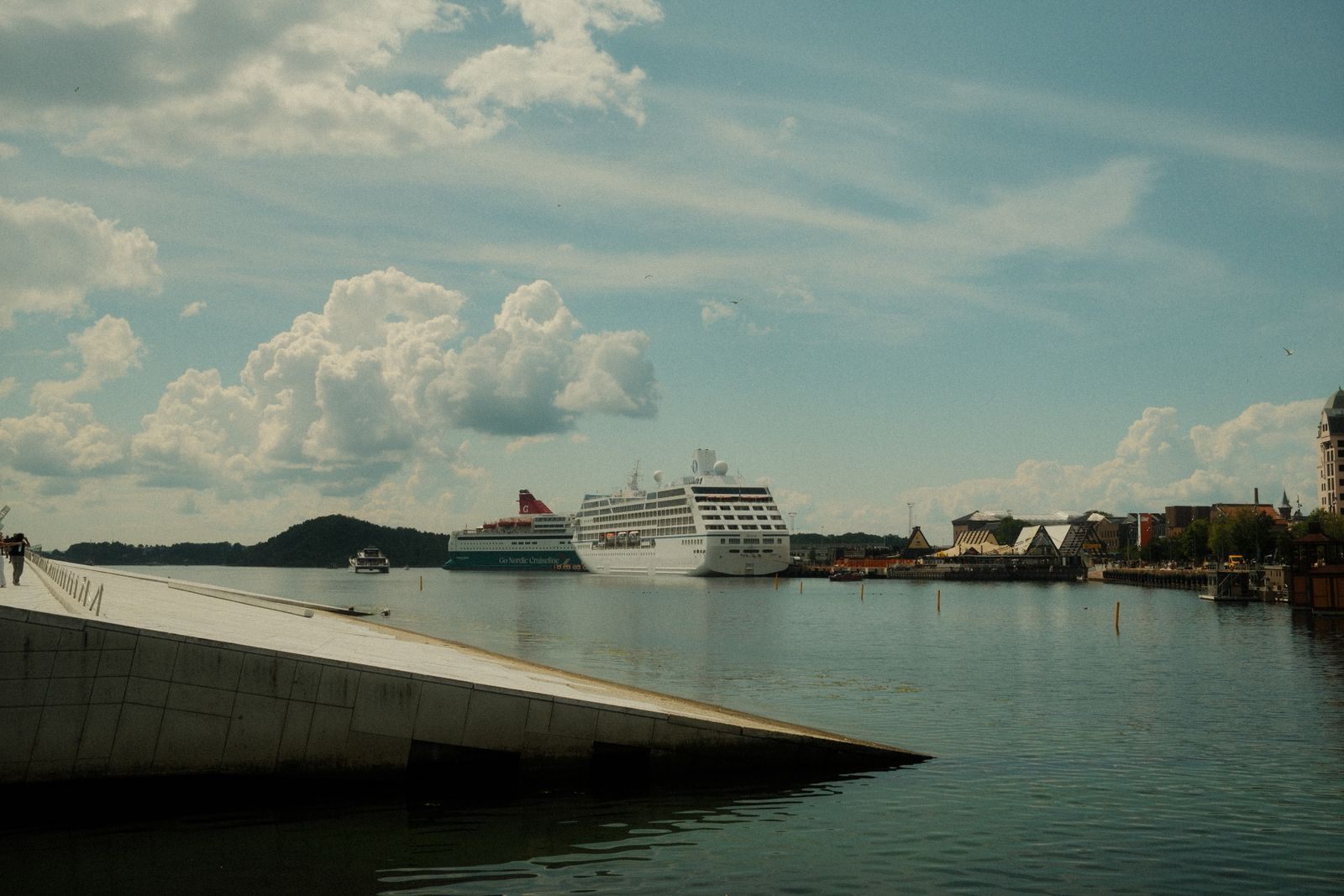 Cruise ships in the Oslo cruise port seen from the sloping marble roof of the Oslo Opera House